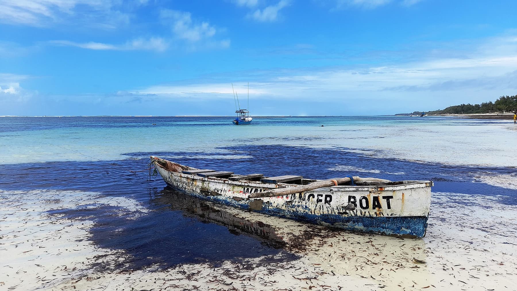 Traditional wooden boat resting on the sand at Diani Beach