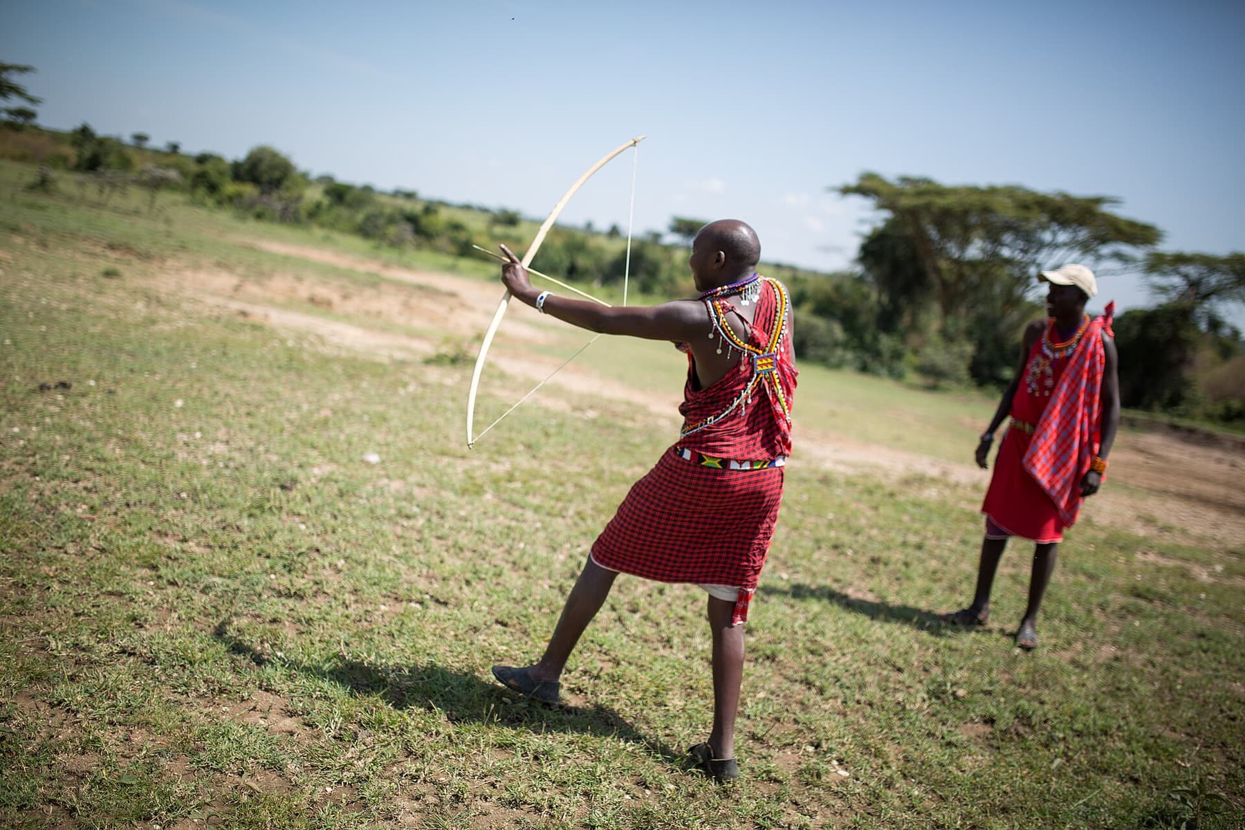 A guide leading travellers on a walking safari in the Mara