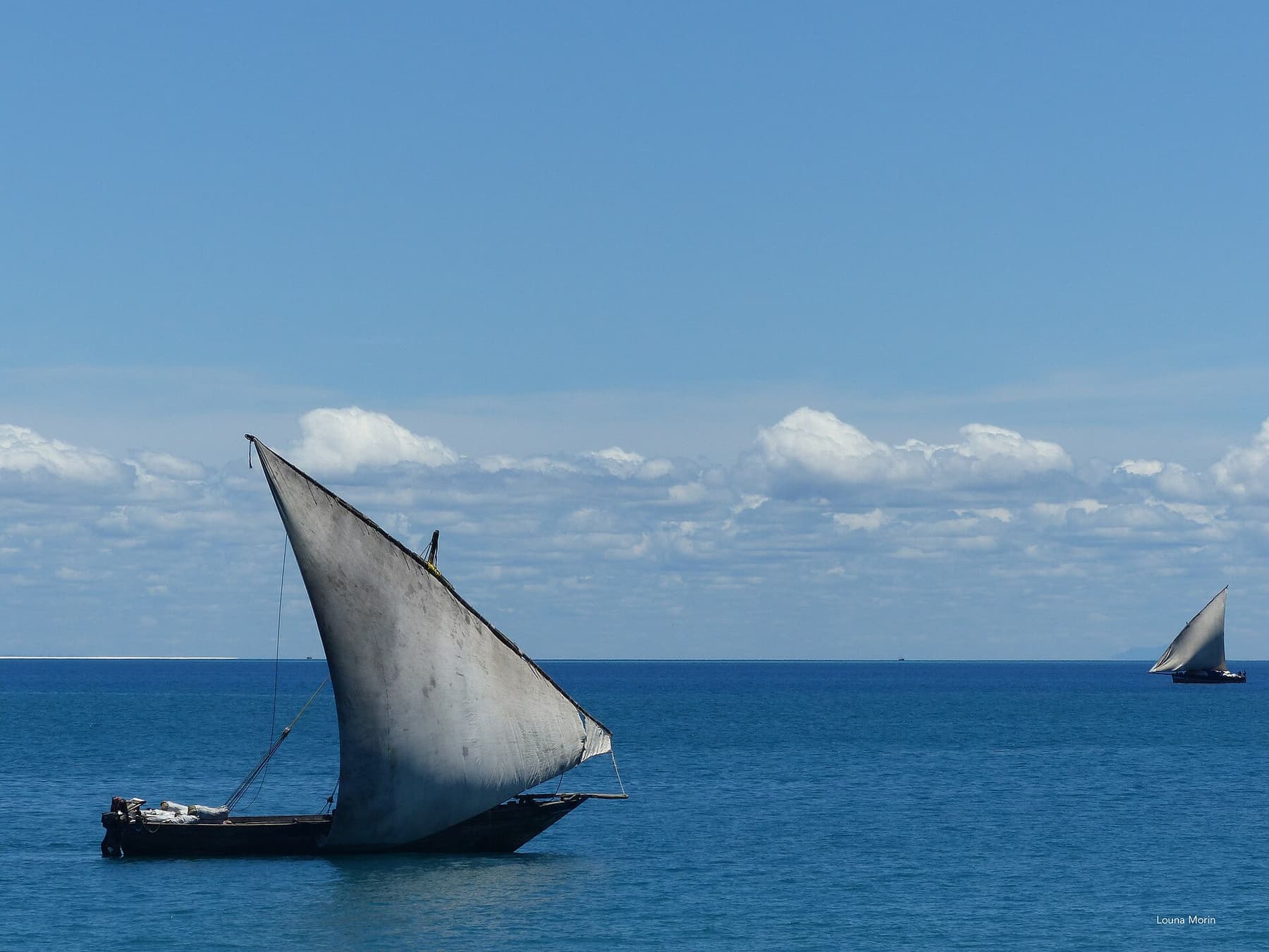 A traditional dhow under sail off the Zanzibar coast
